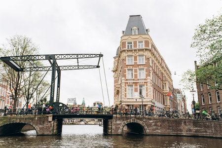 Amsterdam, Netherlands - September 5, 2017: Building of NH Doelen Hotel along canal.のeditorial素材