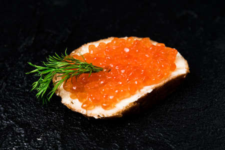 Red caviar with bread on blackの写真素材
