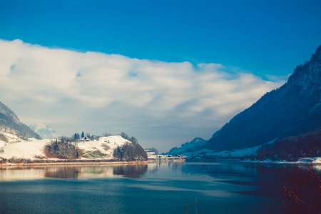 Beautiful winter lake and snowy mountains. Winter landscape