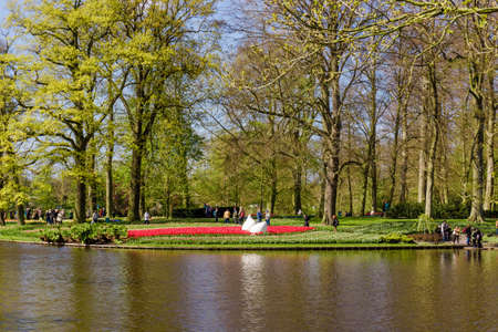 Lisse, Netherlands - April 18, 2016: People and lake in the park of flowers Keukenhofのeditorial素材