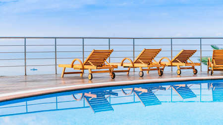 chair around outdoor swimming pool in hotel resort neary sea and beachの写真素材