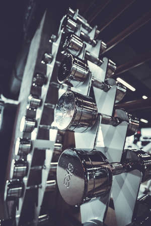 Gym and dumbbell weight training equipment on sportの写真素材