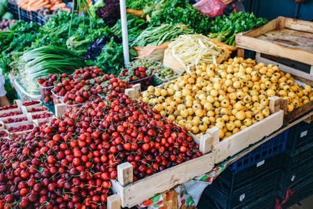 Fresh fruit in the market. Apricots, peaches, cherries, applesの写真素材