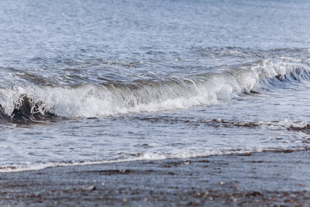 Waves on the beach. A surge of water ashore.