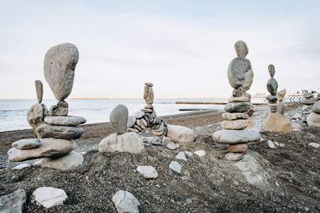 Figures of stones on the beach near the sea. Sea background and stone figures.