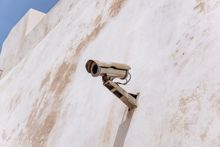CCTV camera on the light wall of the old building