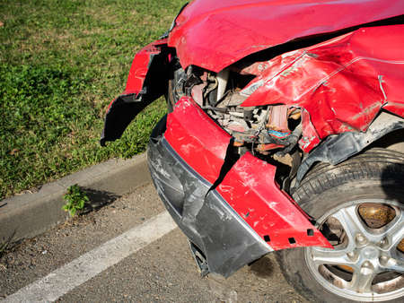 Front of red car get damaged by accident on the roadの写真素材