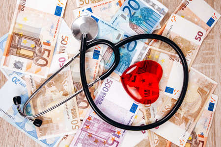 The concept of the cost of medical expenses. The stethoscope and the figure of heart on the Euro banknotesの写真素材