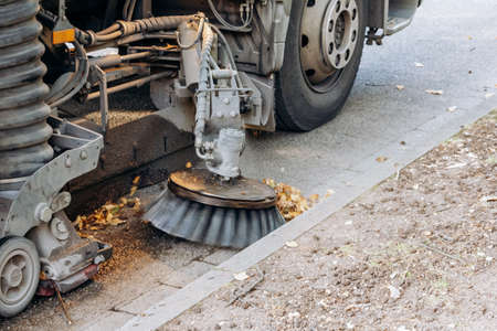 Sweeping machine removes leaves on the streetの写真素材