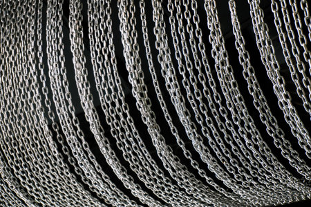 Lots of metal chains on a black background. Background of chains