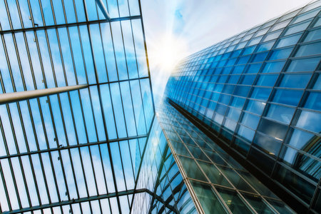 Bottom view of modern skyscrapers in business district against blue sky