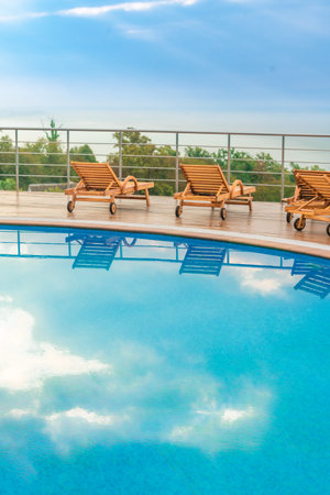 swimming pool near luxury villa. Sunny summer vacation