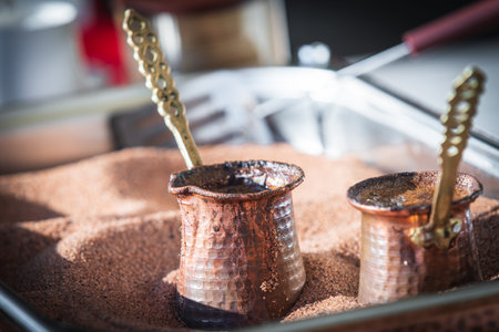Preparation of Turkish coffee in the cezve in the sand の写真素材