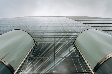 Dramatic view of skyscrapers against cloudy sky. View of the skyscraper from below