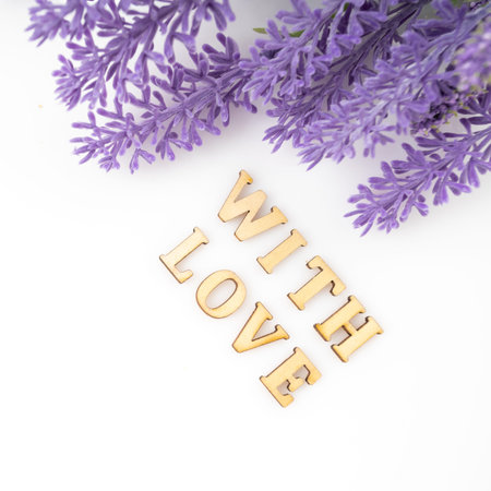 Sign of love with a bunch. Purple flowers petals love text