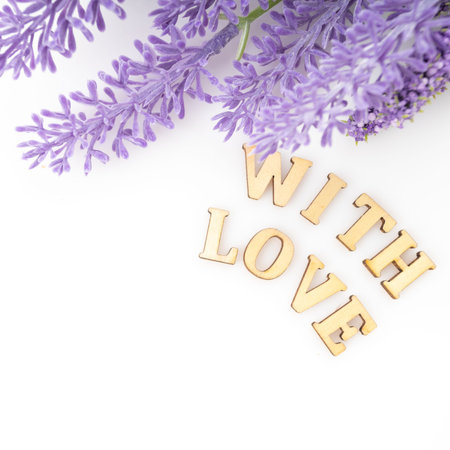 Sign of love with a bunch. Purple flowers petals love textの写真素材