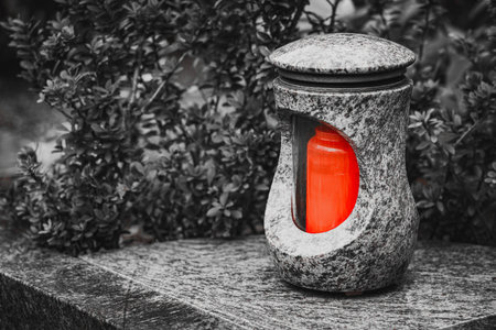 Old damaged grave lantern on a gravestone