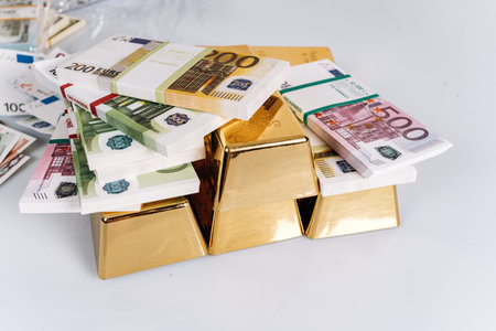 Gold bullions at euro banknotes closeup background. Gold bars lie on Euro banknotesの写真素材