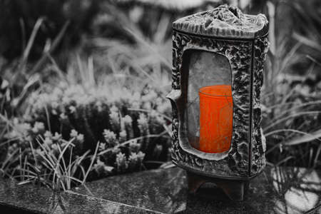 Old damaged grave lantern on a gravestoneの写真素材