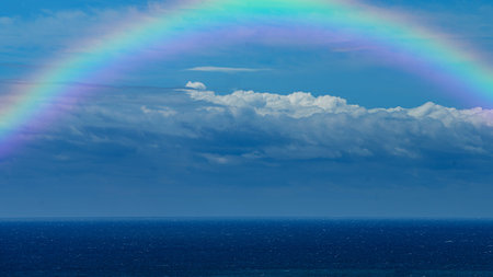 Beautiful sea with a rainbow in the skyの写真素材
