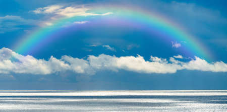 Beautiful sea with a rainbow in the skyの写真素材