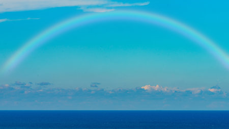 Beautiful sea with a rainbow in the skyの写真素材