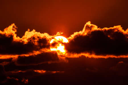 Beautiful colorful orange sky with clouds at sunsetの写真素材