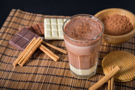 Delicious hot chocolate in a glass with cinnamonの写真素材