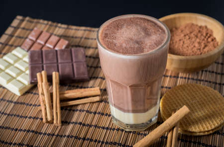 Delicious hot chocolate in a glass with cinnamonの写真素材