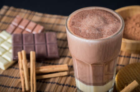 Delicious hot chocolate in a glass with cinnamonの写真素材