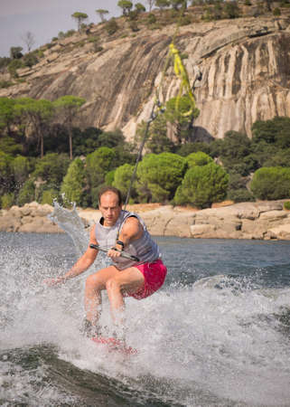 Funny wake-boarding sport on the lakeの写真素材