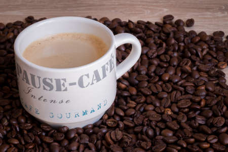 Hot coffee mug on a wood tableの写真素材