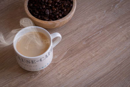 Hot coffee mug on a wood tableの写真素材