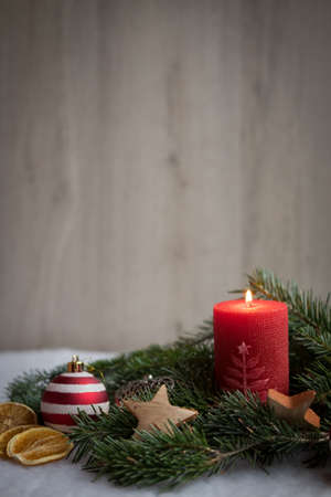 Christmas ornaments with snow, pine tree and candlesの写真素材
