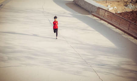 Beautiful athlete woman running on the parkの写真素材