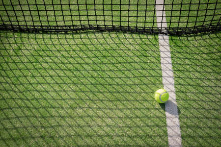 Paddle tennis court and net with a ballの写真素材