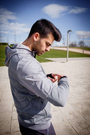 One young caucasian athletic man is preparing before running in a city park in winter.の写真素材