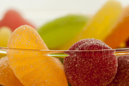 Macro of colorful sour jelly beans candies in a cup