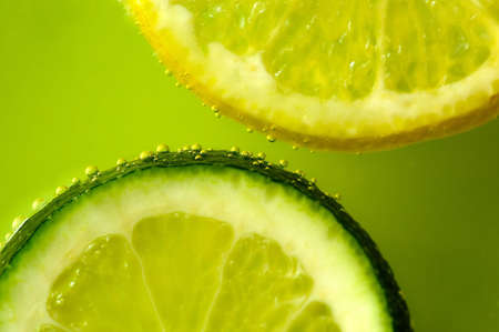 Lime and lemon slices with bubblesの写真素材