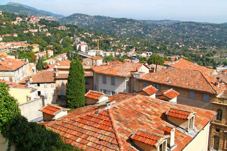 View of houses and red clay tiles roofs of town Grasse in South France.の写真素材