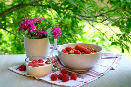 Breakfast with raspberries, yogurt and muesli.の写真素材