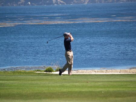 Golfer swing, but the background takes my focus.の写真素材