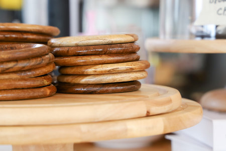 Wooden glass coasters are overlaid each other on big wooden pad. Copy space for relax...
