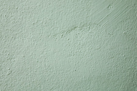 Green cement wall textured background with vignette. Copy space for text and interior textured...
