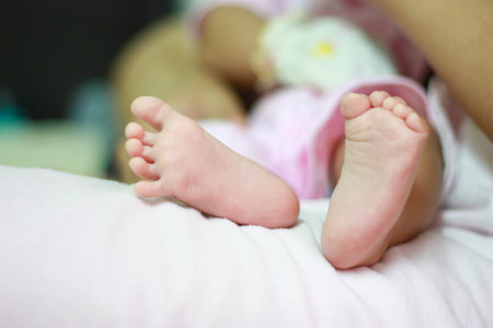 Close up of new born baby feet on parents lap. Concept for love,happy family,parenthood and...