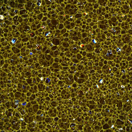 Dark porous sponge made of plastic, close-upの写真素材