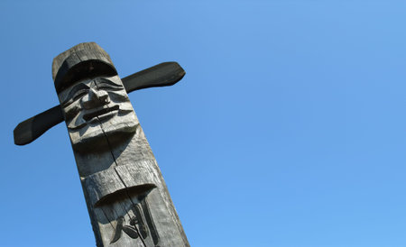 Smiling wooden idol on the background of blue skyの写真素材