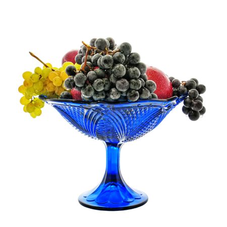 Bunches of grapes, red apples, plum, vase, dropsの写真素材