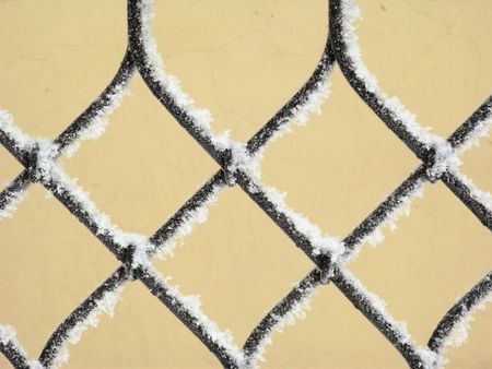 Part of decorative lattice covered with snow, close-upの写真素材