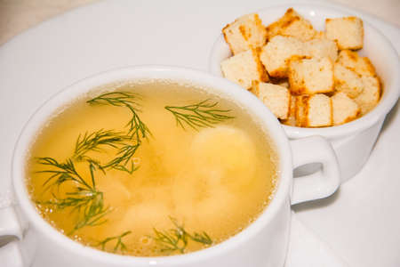 egg soup with herbs and croutonsの写真素材